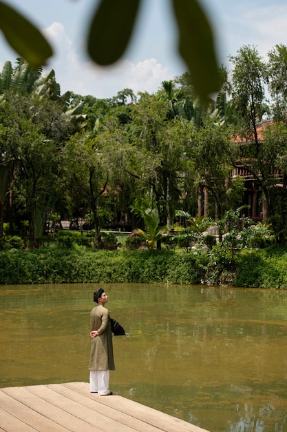 Free photo young man wearing ao dai costume