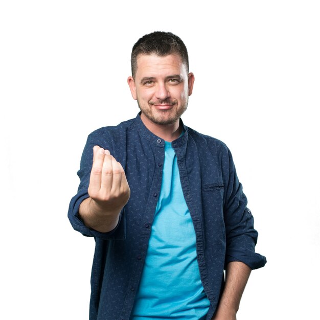 Young man wearing a blue outfit. Doing money gesture.