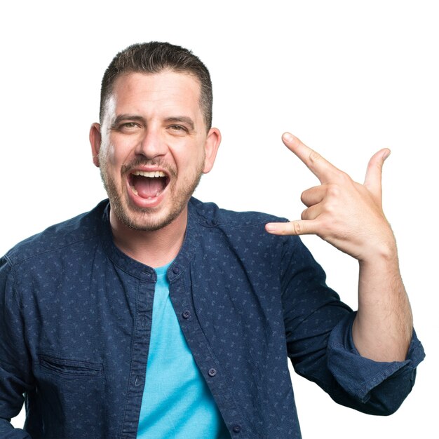 Young man wearing a blue outfit. Doing rock sign.