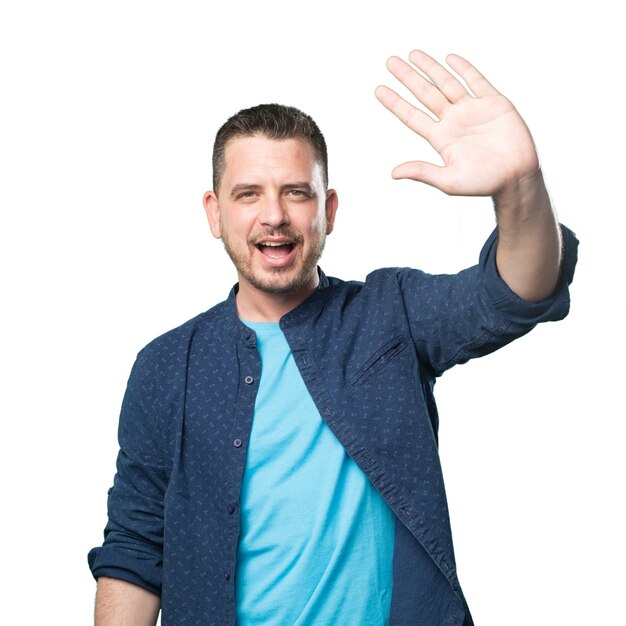 Young man wearing a blue outfit. Greeting gesture.