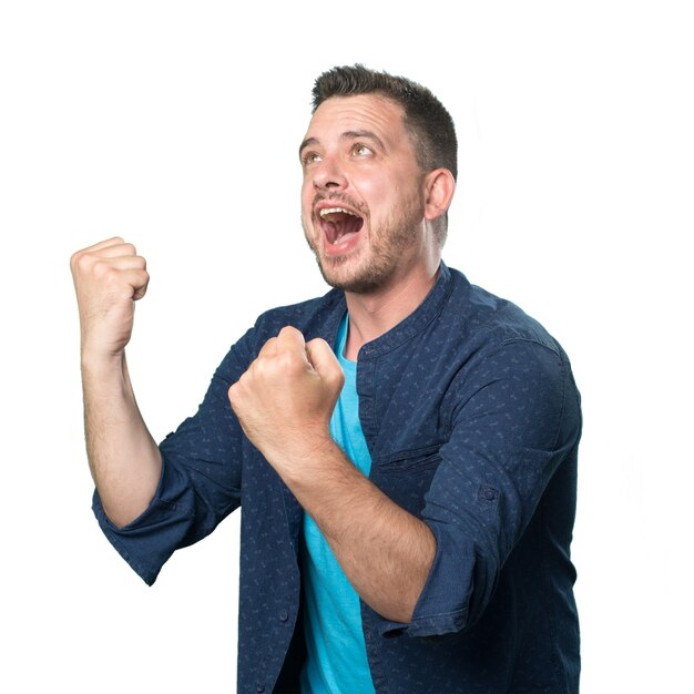 Young man wearing a blue outfit. He is celebrating.