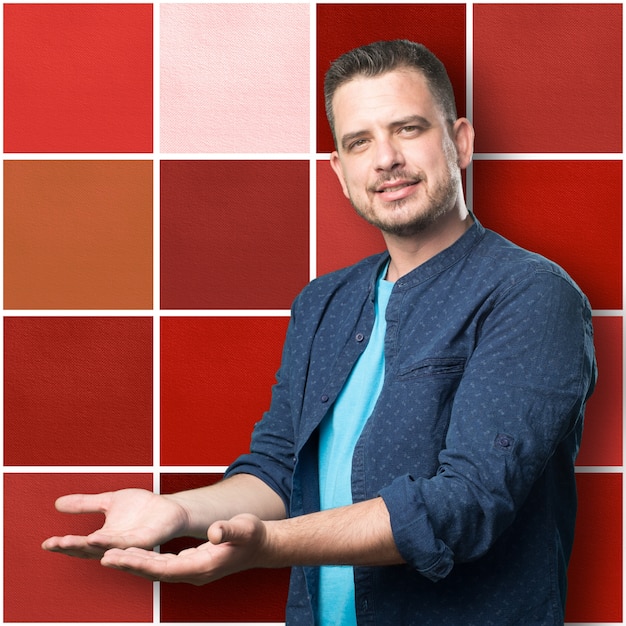 Free photo young man wearing a blue outfit. holding gesture.