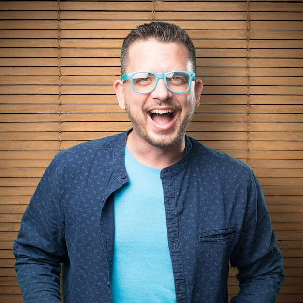 Young man wearing a blue outfit. Looking happy.