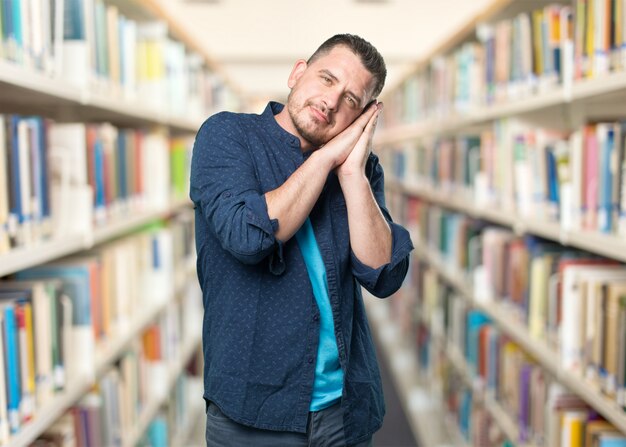 Young man wearing a blue outfit. Looking sleepy.