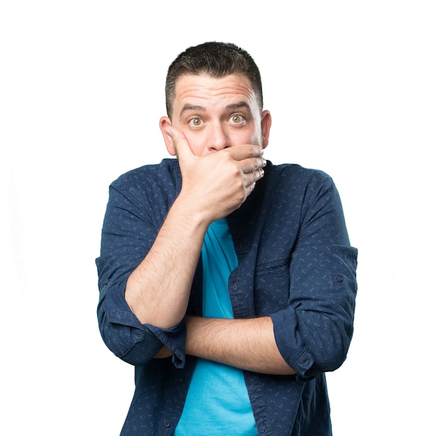 Young man wearing a blue outfit. Looking surpresided and coverin