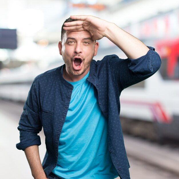 Young man wearing a blue outfit. Looking surprised.