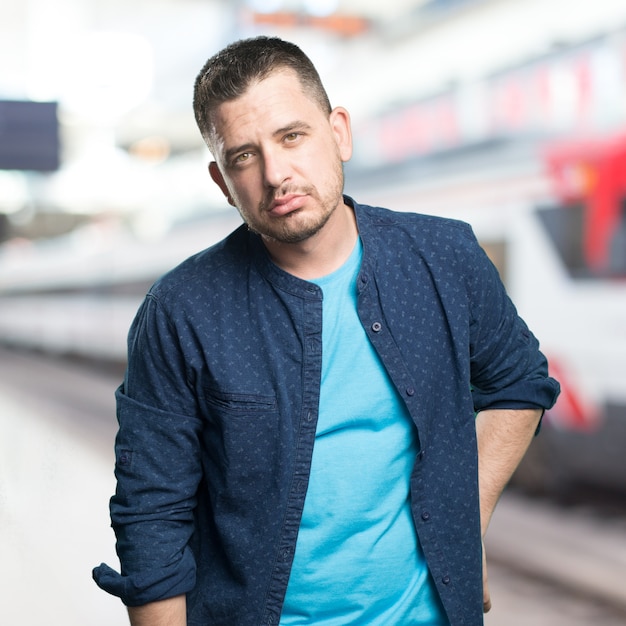 Young man wearing a blue outfit. Looking tired.