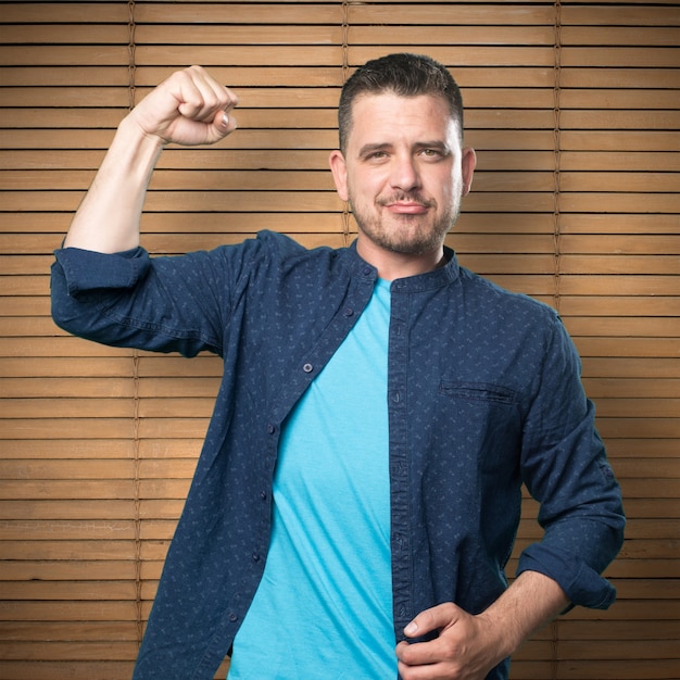 Young man wearing a blue outfit. Showing muscle.