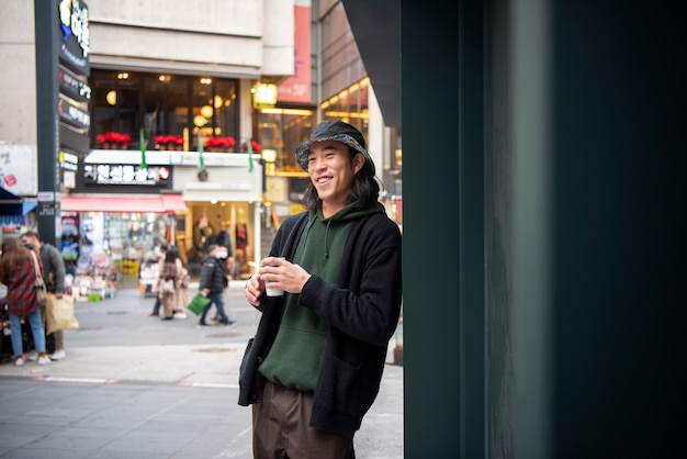 young man wearing a bucket hat in the city