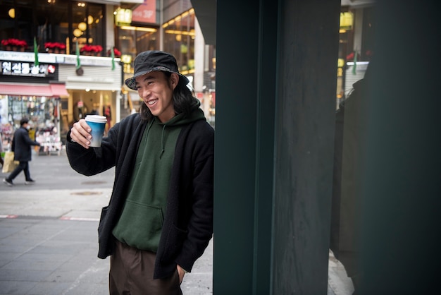 young man wearing a bucket hat in the city