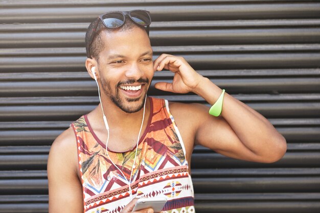 Young man wearing colorful top and sunglasses