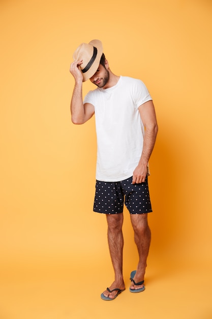 Young man wearing hat standing isolated