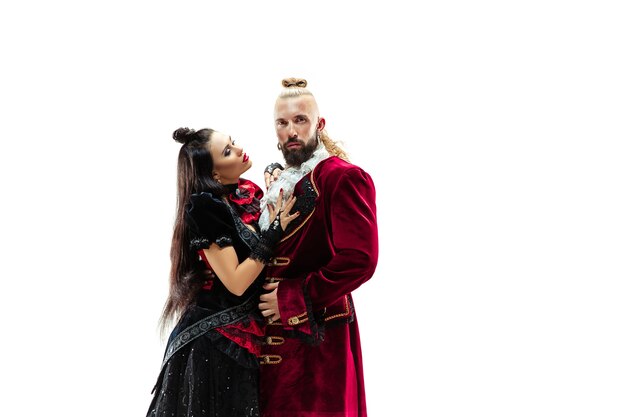 The young man wearing a traditional medieval costume of marquis posing at studio