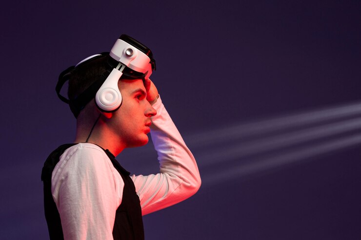 Free Photo young man wearing virtual reality goggles for games