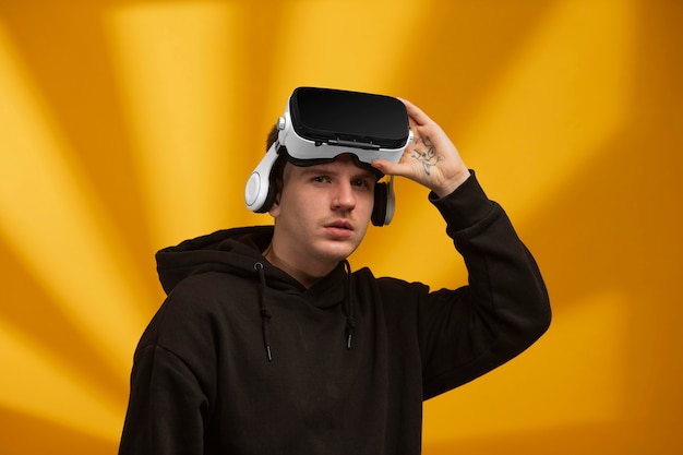 Young man wearing virtual reality goggles on his head