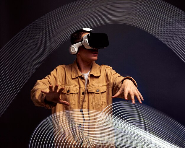 Young man wearing virtual reality goggles with special effects around him