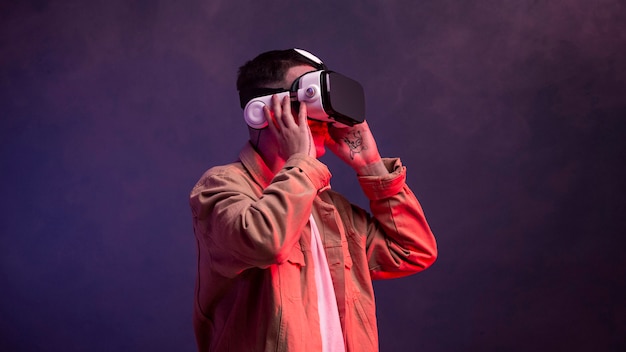 Free photo young man wearing vr goggles for video game