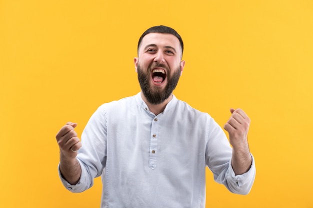 Young man in white shirt with beard posing