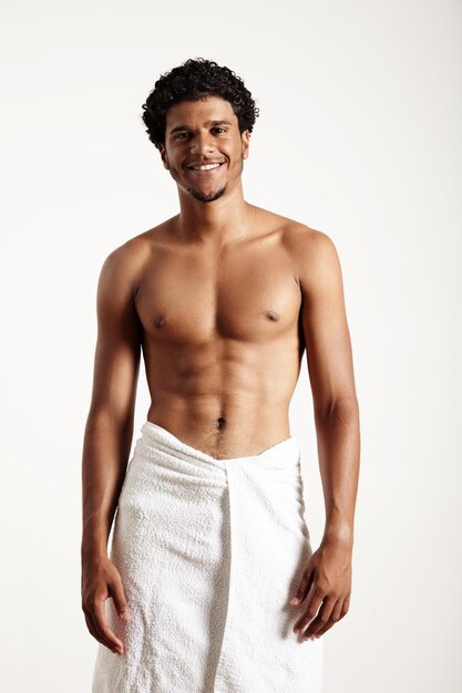 Young man in white towel on a white background