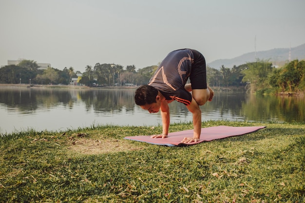 Young man with acrobatic yoga pose