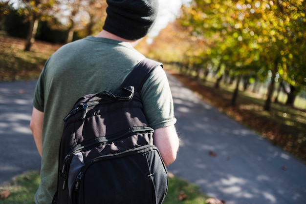 Young man with backpack in the park