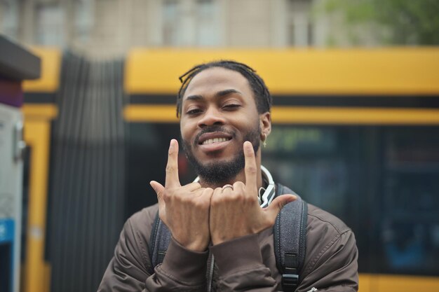 young man with backpack in a tram station