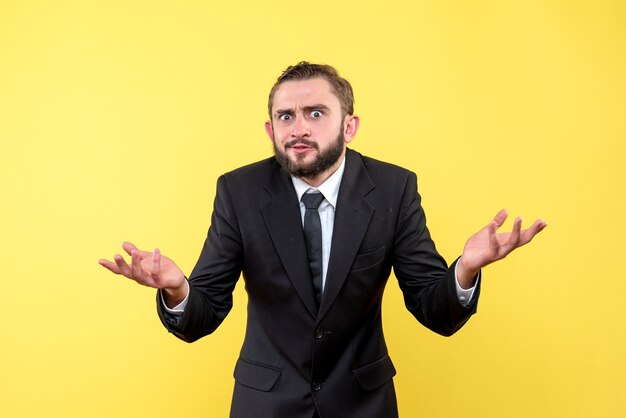 Young man with beard and mustache trying to get answers of his questions on yellow