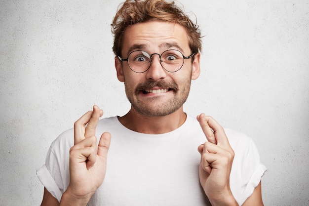 Young man with beard and round glasses