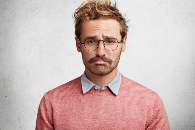 Young man with beard and round glasses