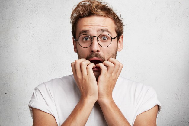 Young man with beard and round glasses