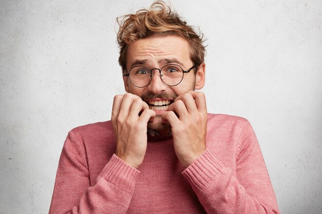 Young man with beard and round glasses