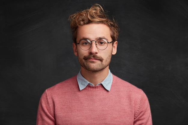 Young man with beard and round glasses