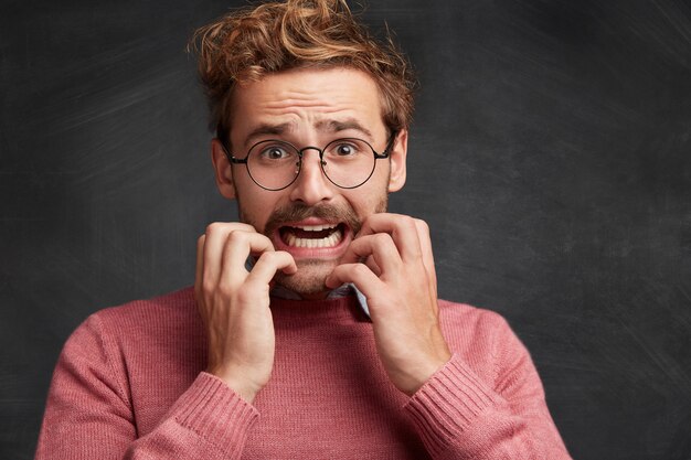 Young man with beard and round glasses