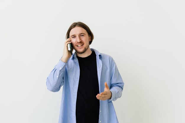 Young man with beard walking and talking with mobile phone