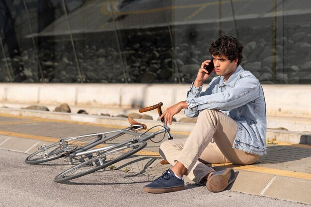 Young man with a bicycle outdoors