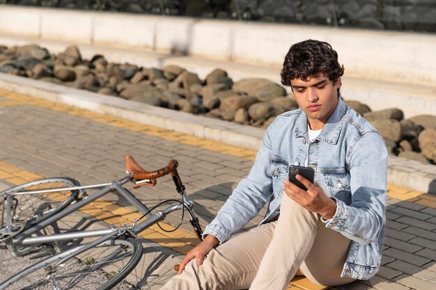 Young man with a bicycle outdoors