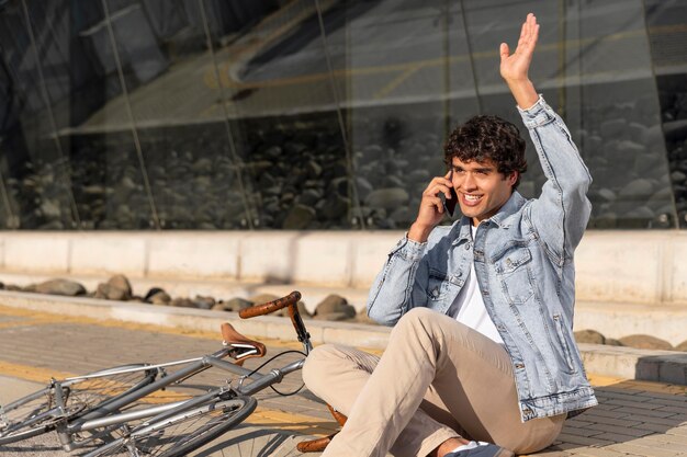 Young man with a bicycle outdoors