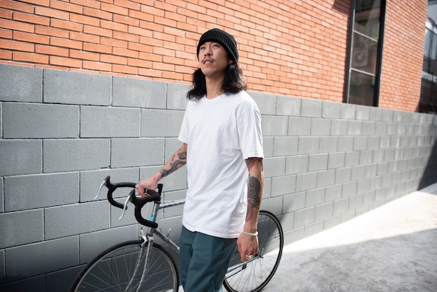 Young man with a bike in the city