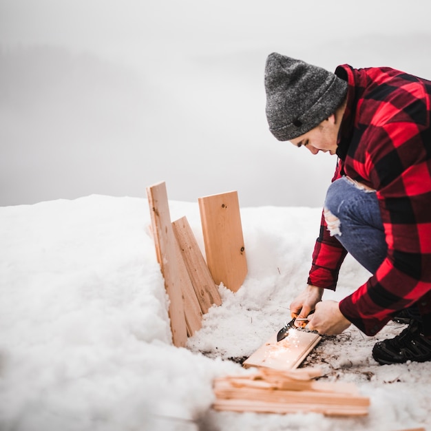 Young man with board on hill