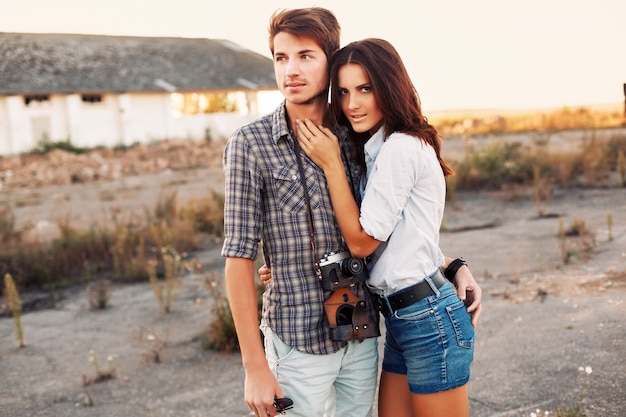 Young man with camera hugging his partner