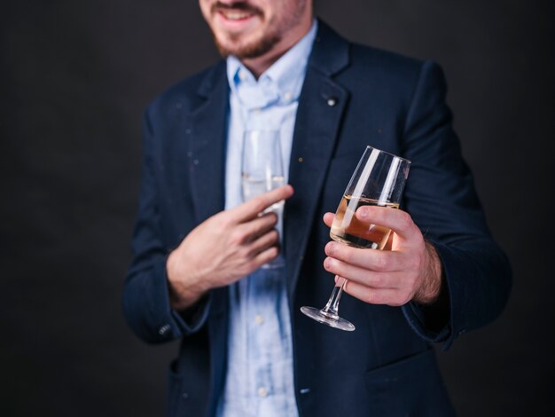 Young man with champagne glasses in hands