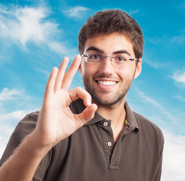 Young man with everything is ok gesture
