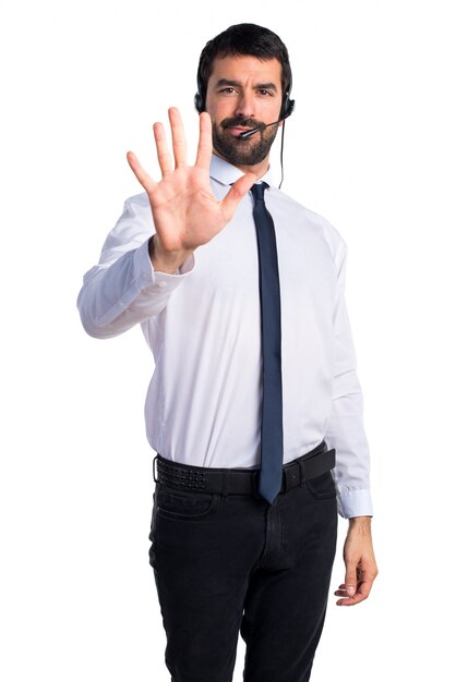 young man with a headset counting five