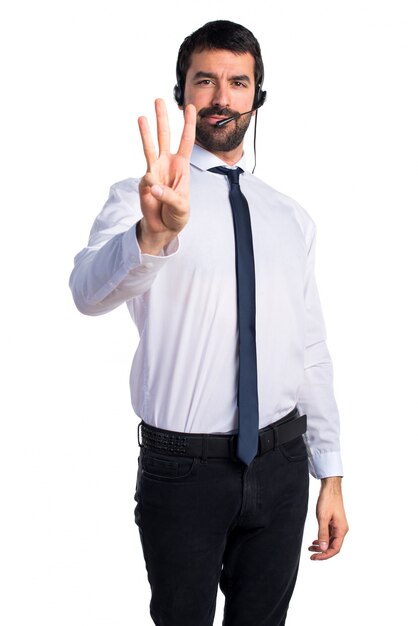 Young man with a headset counting three