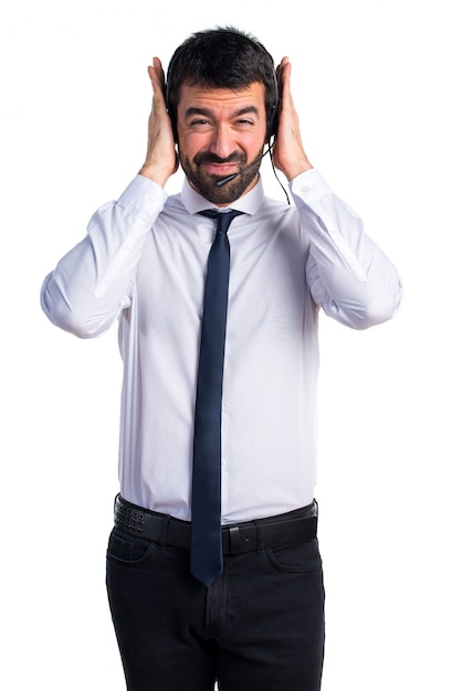 Young man with a headset covering his ears