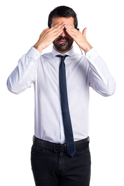 Young man with a headset covering his eyes