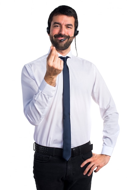 Young man with a headset doing money gesture