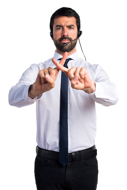 Young man with a headset doing NO gesture