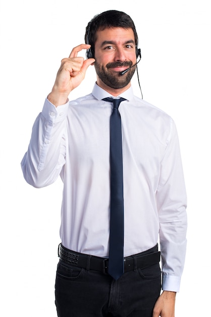 Young man with a headset doing tiny sign