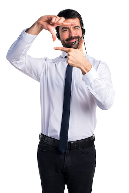 Young man with a headset focusing with his fingers